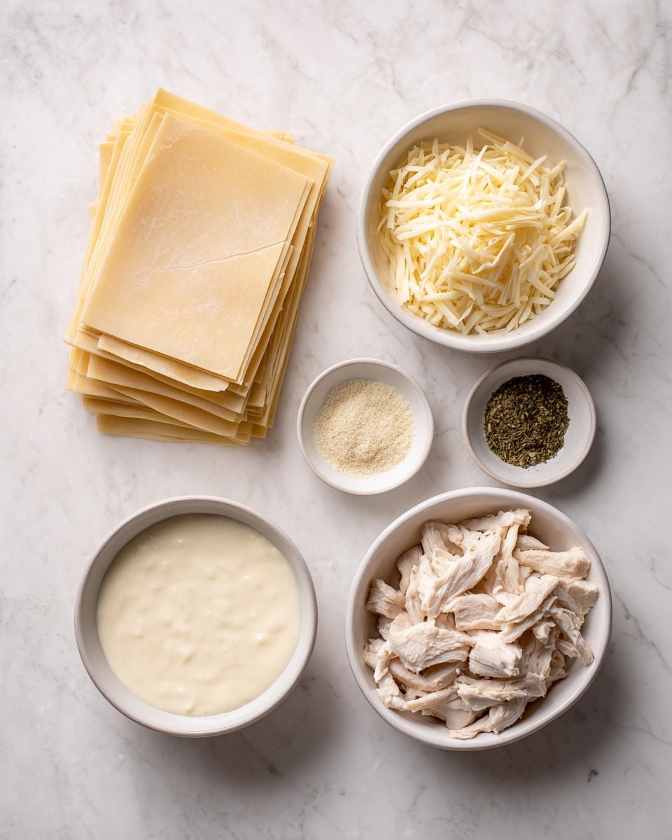 The image shows several cooking ingredients on a white marbled surface. On the left, there is a stack of light beige lasagna noodles neatly placed. To the right of the noodles, there is a white bowl filled with shredded pale yellow cheese. Below the cheese, a small white bowl contains two kinds of seasonings, one in a light beige color and the other green and leafy. Next to the seasonings on the lower right side, there is a white bowl filled with chopped cooked chicken, which is light brown and white. On the bottom left, there is a round white bowl with creamy Alfredo sauce that is pale off-white and smooth in texture. The whole setup is on a white marbled textured surface and the photo was taken with an iphone --ar 4:5 --v 7