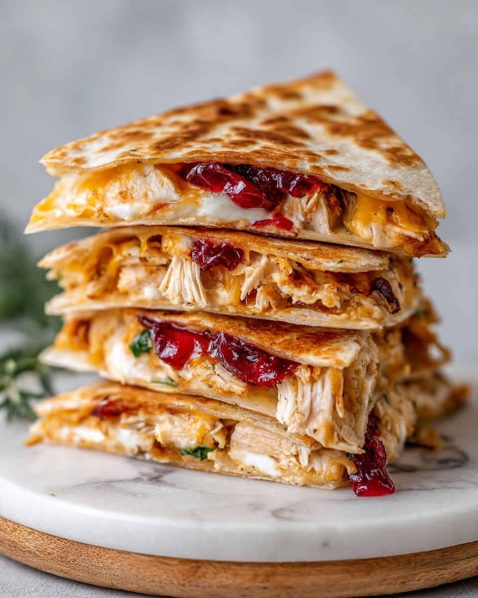 The image shows a single round light brown tortilla on a white plate with a wooden rim, placed on a white marbled surface. On the tortilla, there is a strip of shredded white chicken topped with white shredded cheese and small dollops of red cranberry sauce spread unevenly. Two bright green sage leaves sit on top of the cheese and cranberry layer, adding a fresh color contrast. Photo taken with an iphone --ar 4:5 --v 7