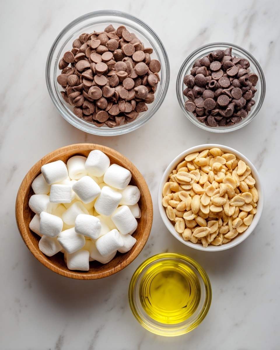 The image shows five bowls arranged on a white marbled surface. At the top left, a glass bowl is filled with milk chocolate chips, which are small, smooth, and brown. To its right, another glass bowl holds semi-sweet chocolate chips, slightly darker in color with a similar smooth texture. Below these, a white bowl contains dry roasted peanuts, which are golden brown and have a rough, uneven surface. At the bottom left, a wooden bowl is filled with mini marshmallows that are white, puffy, and cylindrical. On the bottom right, a small clear glass bowl holds light yellow vegetable oil, appearing shiny and translucent. photo taken with an iphone --ar 4:5 --v 7