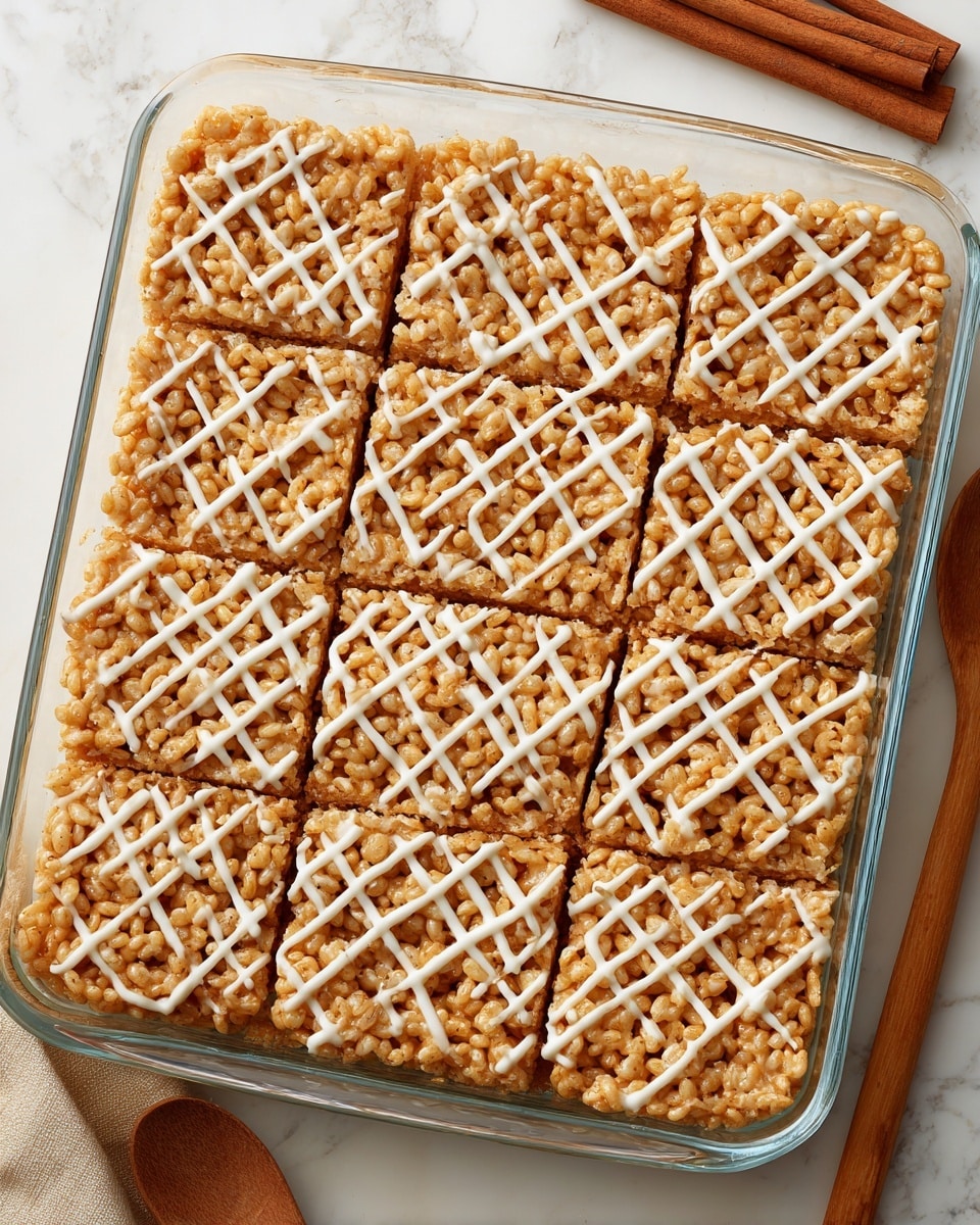 A stack of six light brown crispy rice treats with a rough texture, drizzled with white icing in crisscross patterns on top, is placed on a white plate near the bottom center of the image. Two cinnamon sticks lie beside the stack on the plate. To the upper left, a clear glass jar filled with white milk has a handle facing left and is sitting on a white marbled surface. More rice treats with white icing drizzle are scattered near the jar on the right side. A white cloth with black lines rests behind the jar. The overall scene is bright and clean with simple elements. photo taken with an iphone --ar 4:5 --v 7