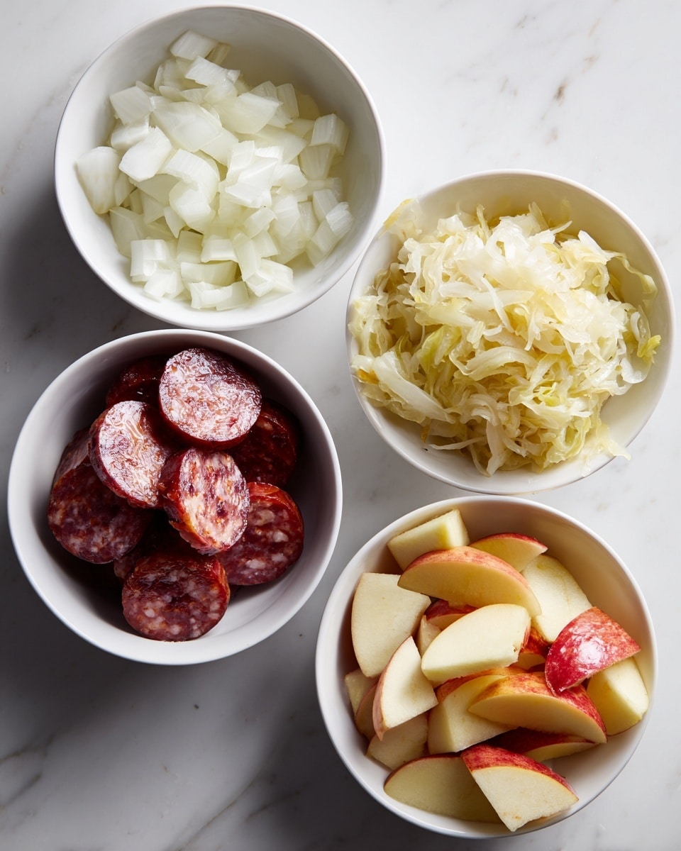 Four white bowls are placed on a white marbled surface. The top left bowl contains small chopped white onions with a shiny, slightly translucent texture. The top right bowl holds a fluffy layer of pale yellow shredded cabbage or sauerkraut with a soft, fibrous look. The bottom left bowl is filled with thick slices of shiny, reddish-brown sausage with visible white fat bits inside. The bottom right bowl shows peeled and chopped apple pieces with light yellow flesh and red skin on the edges. photo taken with an iphone --ar 4:5 --v 7