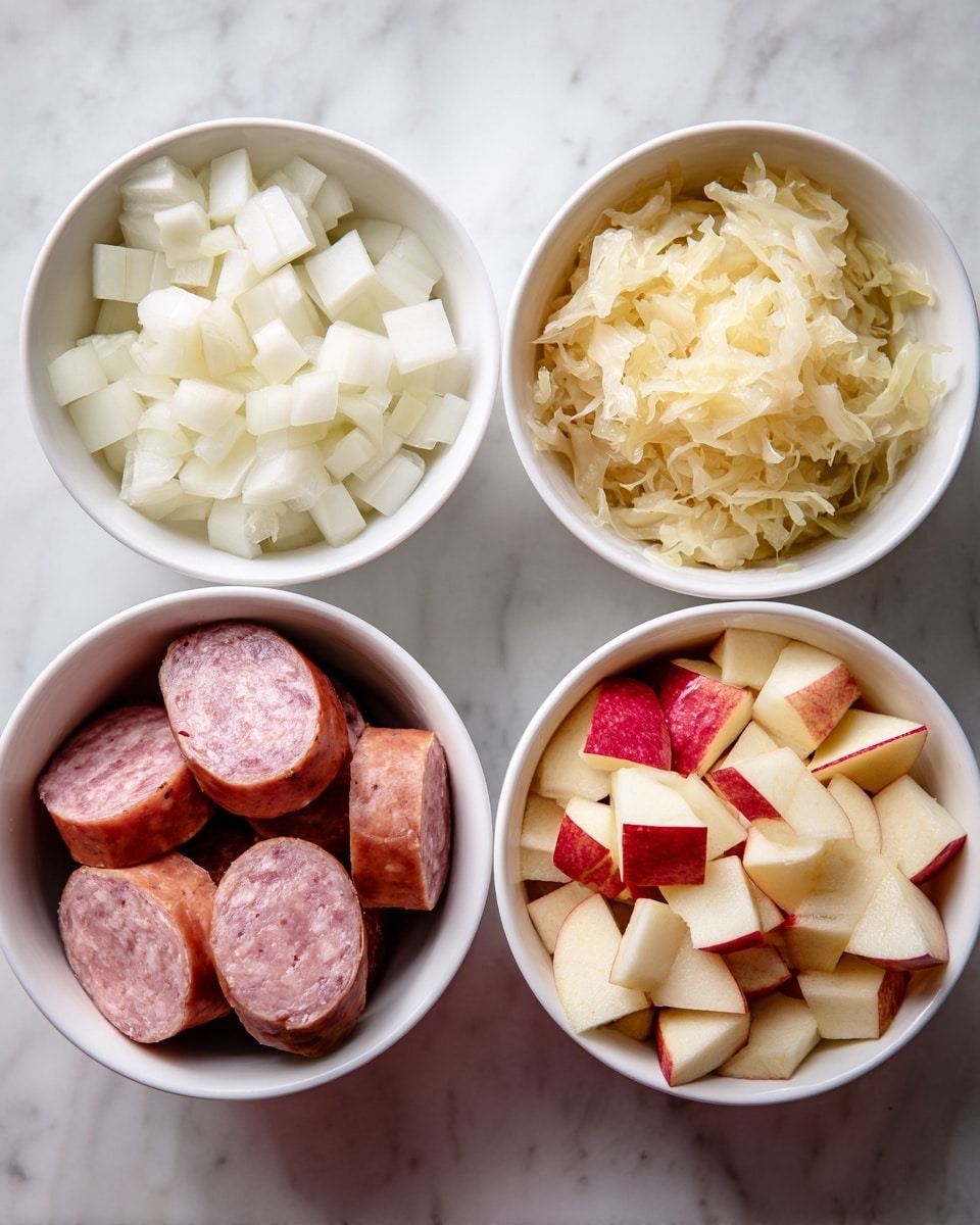 The image shows four white bowls on a white marbled surface, each filled with different ingredients. The top left bowl has several layers of small, white, cubed onions with a soft texture. The top right bowl contains light yellow sauerkraut with a thin, shredded texture filling the bowl. The bottom left bowl has large, thick slices of smoked sausage with a smooth, reddish-brown outer skin and a pinkish interior. The bottom right bowl holds cubed apples with red skin edges and pale yellow flesh, stacked loosely. Each bowl's contents display a distinct color and texture that contrasts with the white bowls and the marbled surface. Photo taken with an iphone --ar 4:5 --v 7